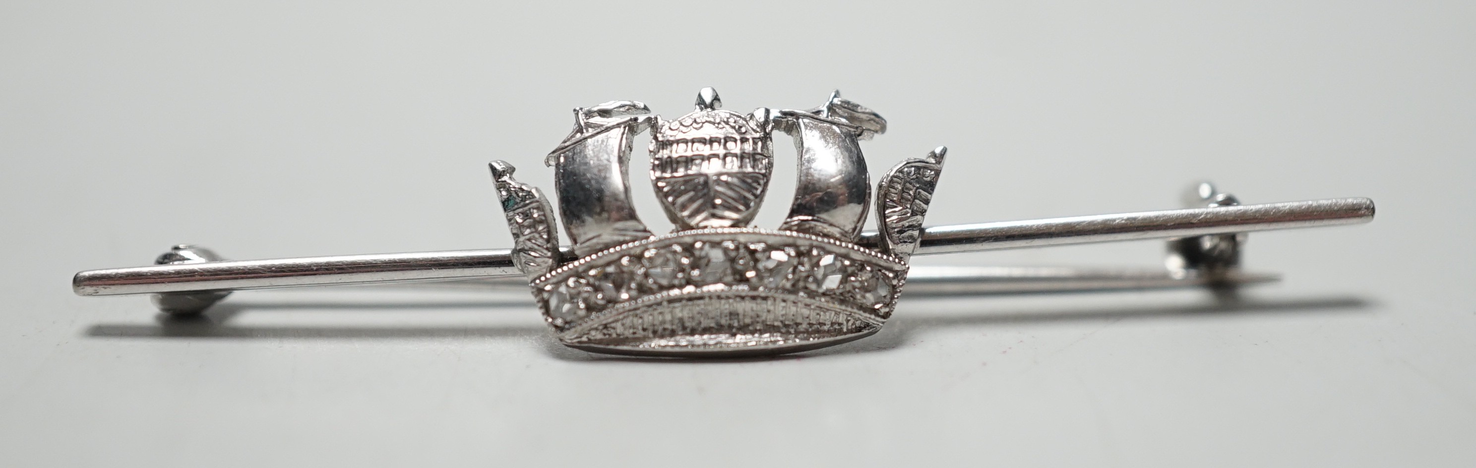 An 18ct, plat and rose cut diamond chip set coronet bar brooch, 50mm, gross weight 4.5 grams.
